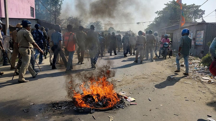 Security personnel try to control the situation after violent protests by locals over the death of a minor girl, in North Dinajpur district of West Bengal. Credit: PTI Photo
