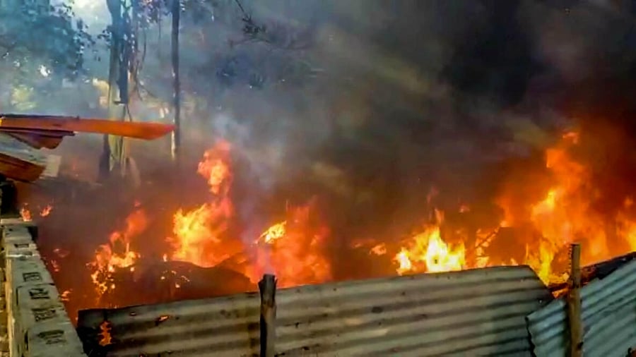 Flames billow out after a group of protesters allegedly set Kaliaganj Police Station on fire. Credit: PTI Photo