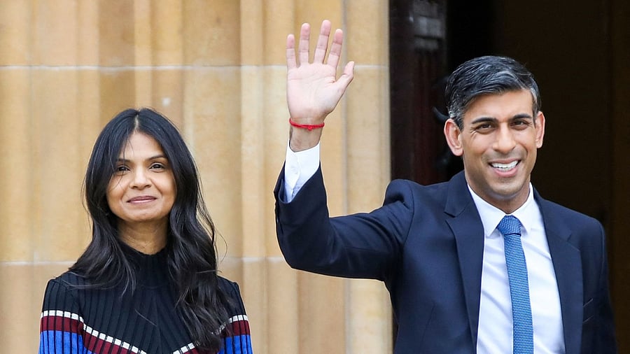 Britain's Prime Minister Rishi Sunak (R), flanked by his wife Akshata Murty (L). Credit: AFP Photo