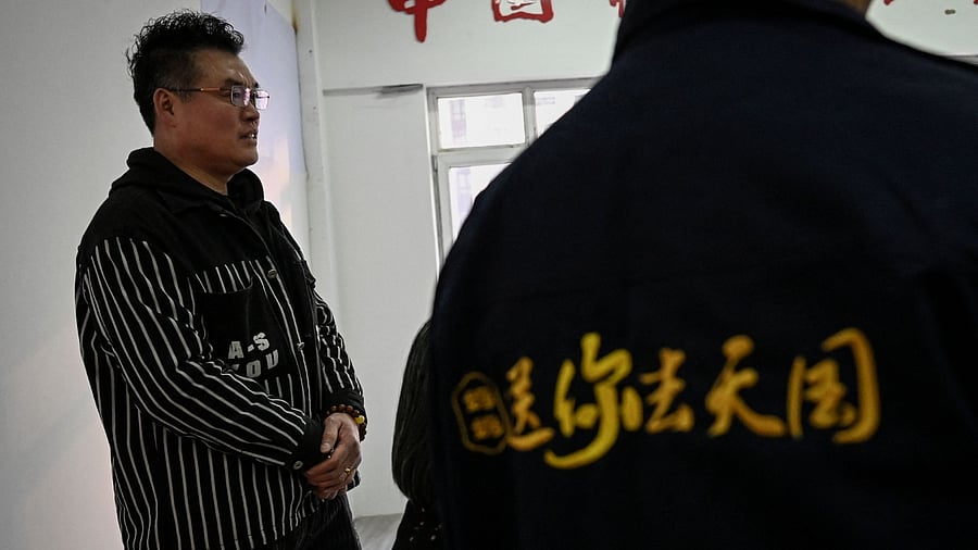 This photo taken on March 29, 2023 shows mortician Cao Yongsheng, a reformed criminal who spent years in prison, standing inside his funeral services shop in Shenyang city, in northeastern China's Liaoning province. Credit: AFP Photo