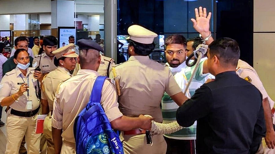 File photo of cops taking custody of Manish Kashyap at Jaiparaksah Narayan Airport, in Patna. Credit: PTI