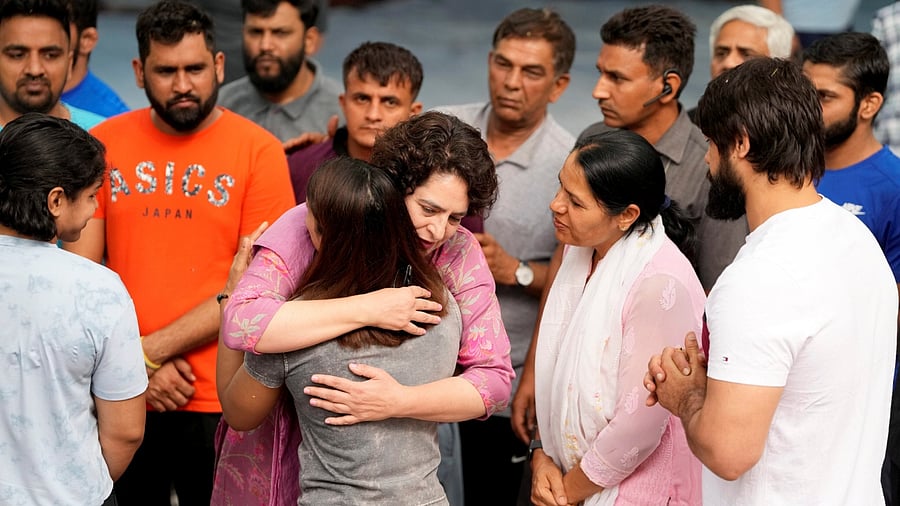 Congress leader Priyanka Gandhi embraces wrestler Vinesh Phogat at Jantar Mantar, in New Delhi, Saturday, April 29, 2023. Credit: PTI Photo