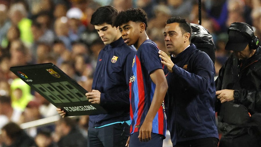 FC Barcelona's Lamine Yamal with coach Xavi. Credit: Reuters Photo