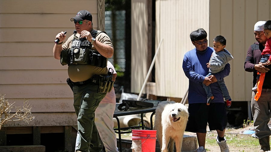 Law enforcement officials work Sunday, April 30, 2023, in the neighborhood where a mass shooting occurred Friday night, in Cleveland, Texas. The search for a man who allegedly shot his neighbors after they asked him to stop firing off rounds in his yard stretched into a second day Sunday, with authorities saying the man could be anywhere by now. Francisco Oropeza, 38, fled after the shooting Friday night that left several people dead, including a young boy. Credit: AP/PTI Photo