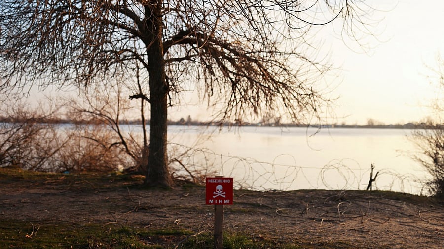 A view of a mine danger sign in front of Dnipro river, amid Russia's invasion of Ukraine, in Kherson. Credit: Reuters Photo