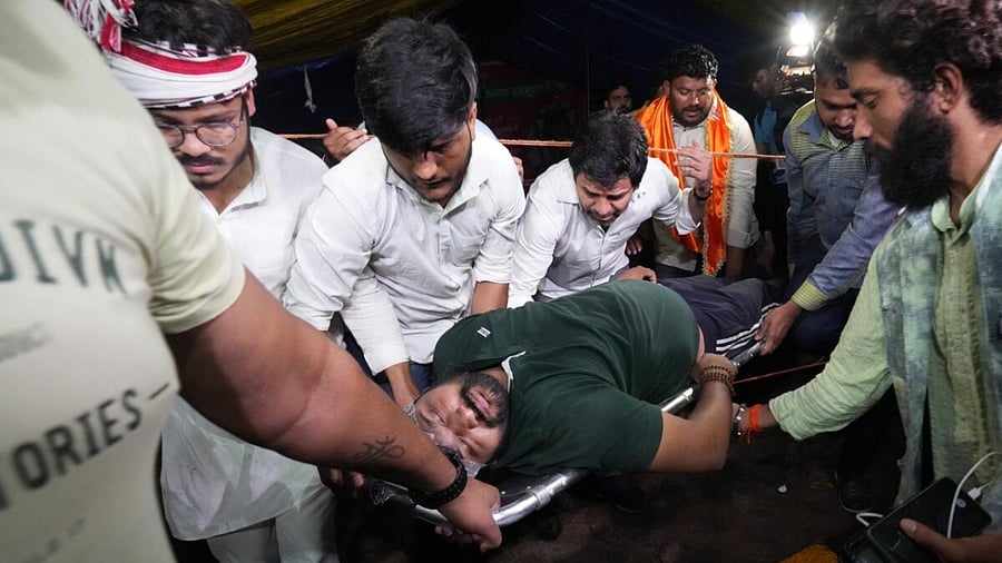 Injured wrestler being taken to an ambulance after a scuffle between wrestlers and the police at Jantar Mantar, in New Delhi. Credit: PTI Photo