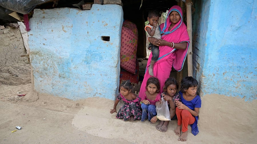In this photograph taken on April 27, 2023, Gita Devi, mother-of-five, poses with her children at her village house in Darbhanga district of Bihar. Credit: AFP Photo