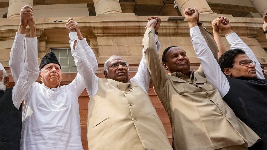 Leader of Opposition in Rajya Sabha Mallikarjun Kharge, DMK MP TR Baalu, JKNC MP Farooq Abdullah and Samajwadi Party MP Ram Gopal Yadav form a human chain to protest over the Adani issue, at Parliament House complex in New Delhi, Thursday, March 16, 2023. Credit: PTI Photo