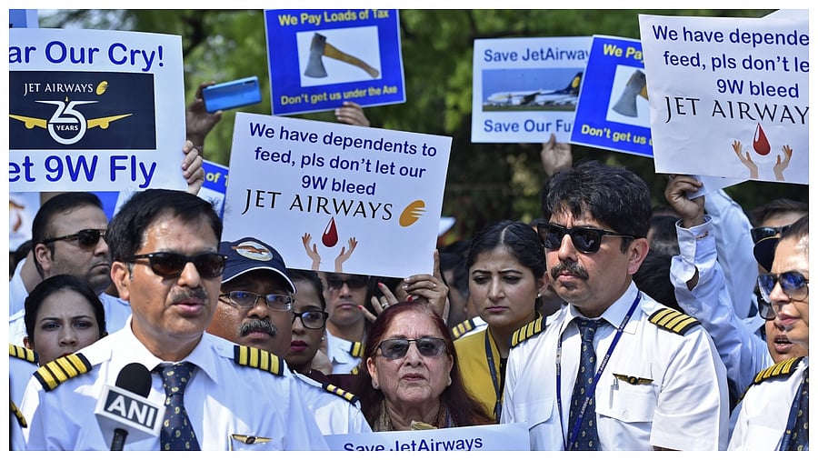 Pilots, cabin crew and ground staff hold placards during a protest organized by Jet Airways India employees in Delhi in 2019. Credit. Bloomberg