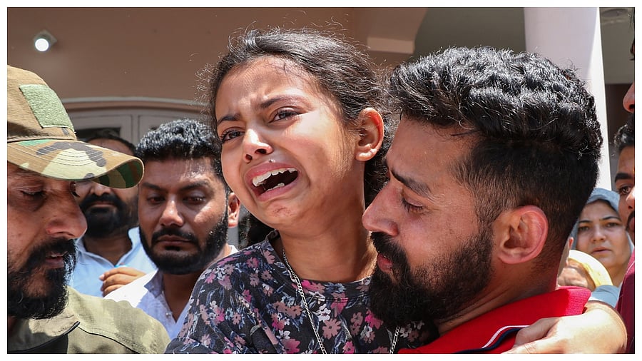 Daughter of Indian Army's Havildar Neelam Singh reacts after his mortal remains were brought at his residence. Credit: PTI Photo