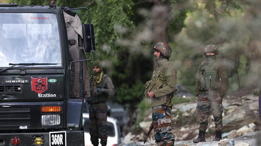 Security personnel near the site of an encounter with terrorists in Kandi area of Rajouri district. Credit; PTI Photo