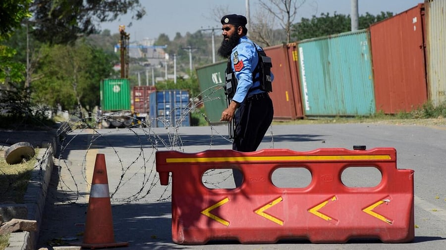A police officer puts barbed wire to block a road leading to the main entrance of Police Lines, where Pakistan's former Prime Minister Imran Khan is being kept after his arrest, in Islamabad, Pakistan May 10, 2023. Credit: Reuters Photo