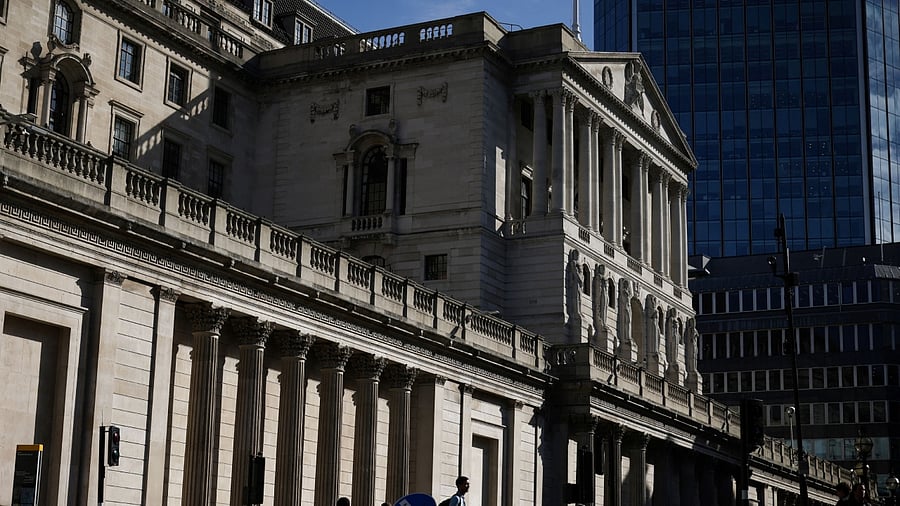 People walk outside the Bank of England in the City of London financial district in London. Credit: Reuters Photo