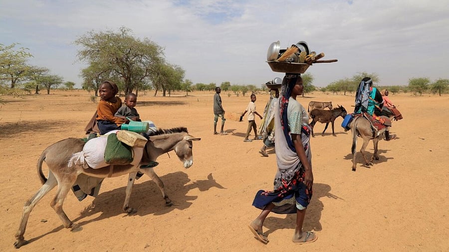 Sudanese families fleeing the conflict in Sudan's Darfur region, make their way through the desert after they crossed the border between Sudan and Chad to seek refuge in Goungour, Chad May 12, 2023. Credit: Reuters Photo