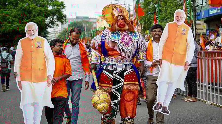 A BJP supporter dressed as Lord Hanuman during Prime Minister Narendra Modi's road show campaign, before Karnataka went to the polls, in Bengaluru, May 6, 2023. Credit: PTI Photo