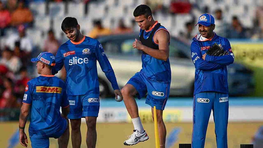 Mumbai Indians' Arjun Tendulkar (2R) warms up before the start of the Indian Premier League (IPL) Twenty20 cricket match between Punjab Kings and Mumbai Indians at the Punjab Cricket Association Stadium in Mohali on May 3, 2023. Credit: AFP Photo