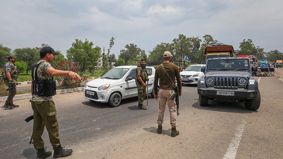J&K Police Special Operations Group (SOG) personnel check vehicles on Jammu-Pathankot Highway amid a high alert, ahead of G20 meeting, in Srinagar. Credit: PTI Photo