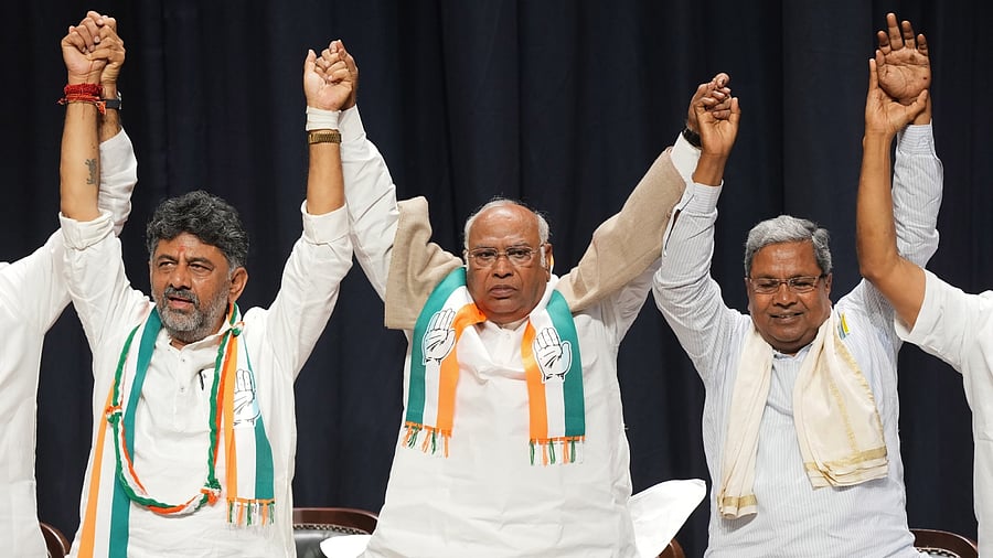 Congress President Mallikarjun Kharge with former Karnataka CM Siddaramaiah and Karnataka Congress President D.K. Shivakumar during celebrations after the party's win in Karnataka Assembly elections, in Bengaluru, Saturday, May 13, 2023. Credit: PTI Photo