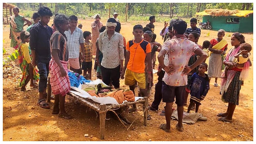 Villagers gather near the body of a 10-year-old boy, who was killed when an Improvised Explosive Device (IED) allegedly planted by CPI (Maoists) exploded, in Jharkhand's West Singbhum district, Friday, May 19, 2023. Credit: PTI Photo
