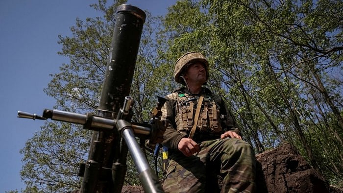 A Ukrainian service member prepares to fire a mortar at a front line near the city of Bakhmut. Credit: Reuters Photo