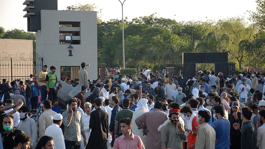 Pakistan Tehreek-e-Insaf (PTI) party activists and supporters of former Pakistan's Prime Minister Imran gather in fornt of the main entrence of General Headquarters, Pakistan's army headquater, during a protest against the arrest of their leader, in Rawalpindi on May 9, 2023. Credit: AFP Photo