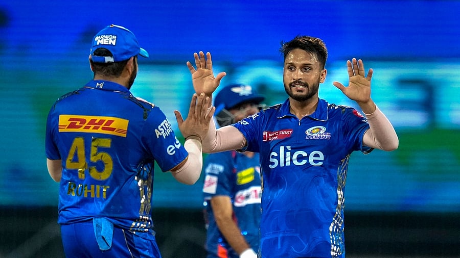 Mumbai Indians bowler Akash Madhwal celebrates with teammate Rohit Sharma. Credit: PTI Photo