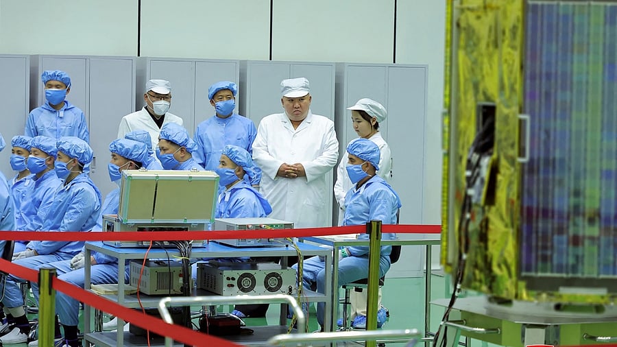 Kim Jong-un inspects a military reconnaissance satellite in North Korea. Credit: AFP Photo/KCNA via KNS
