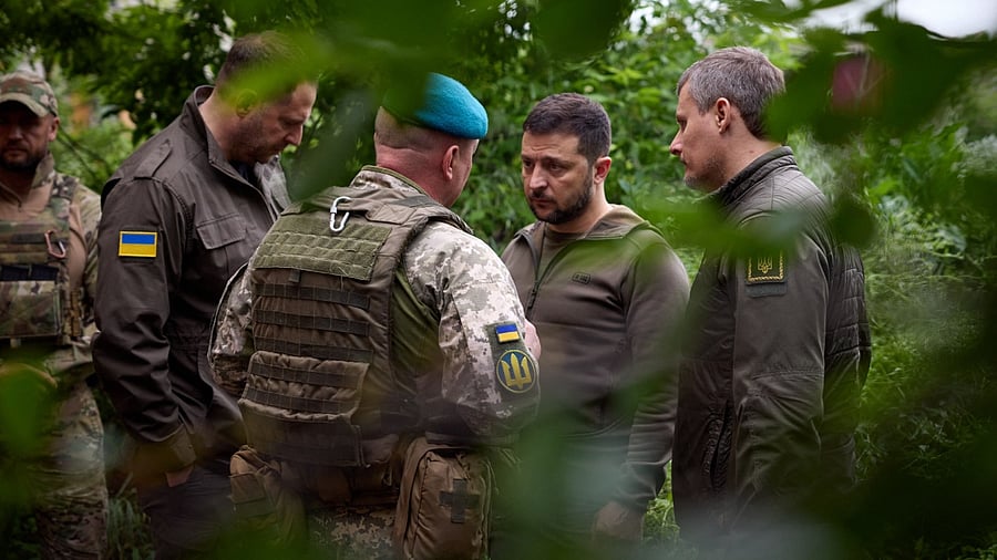 Ukraine President Volodymyr Zelenskyy interacts with Ukrainian servicemen. Credit: AFP Photo