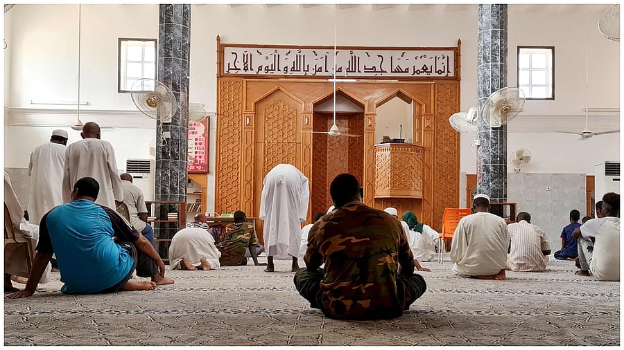 Sudanese people gather in a mosque, where electricity is available via generator, after power cuts in Khartoum on May 26, 2023. Fighting between forces loyal to Sudan's rival generals rocked the western region of Darfur. Credit: AFP Photo