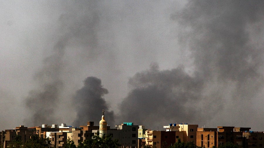 Smoke rises above buildings in Khartoum on May 24, 2023. Credit: AFP Photo