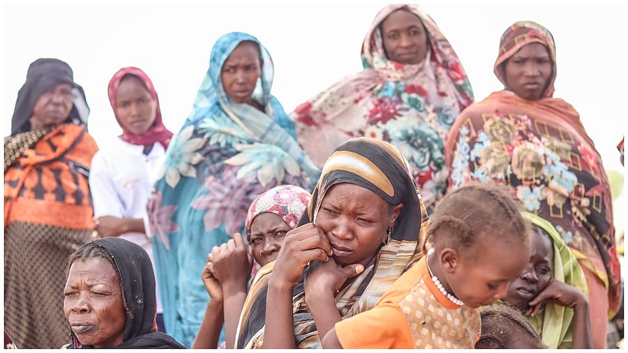 Sudanese refugees from the Tandelti area who crossed into Chad, in Koufroun, near Echbara, gather on April 30, 2023 for an aid distribution. Credit: AFP Photo