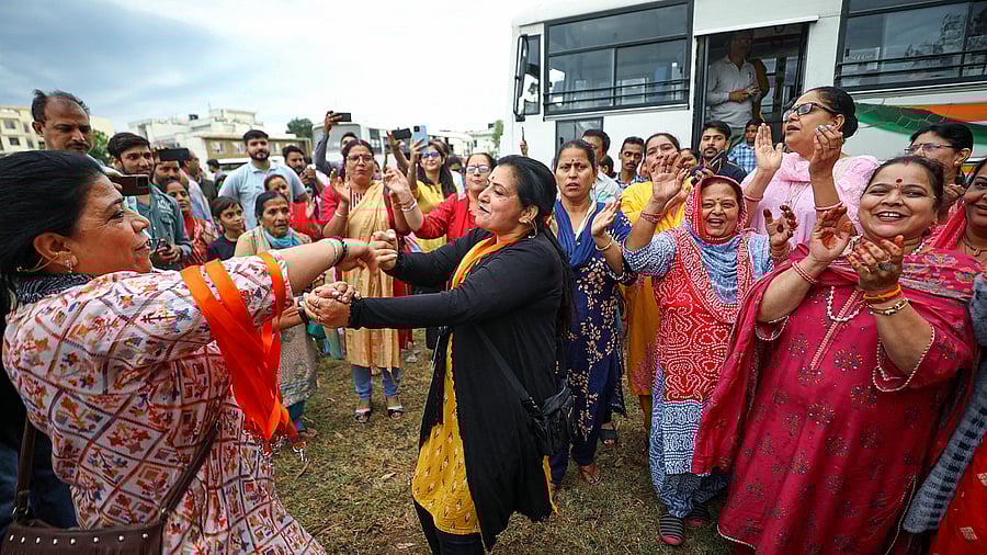 A devotee pours oil in earthen lamps on the eve of the Kheer Bhawani Mela, in Jammu, Saturday, May 27, 2023. Credit; PTI Photo