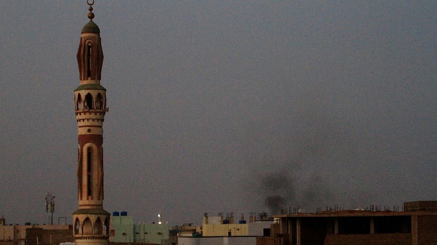 Smoke billows behind buildings in southern Khartoum, on May 27, 2023, amid ongoing fighting between the forces of two rival generals. Credit: AFP Photo