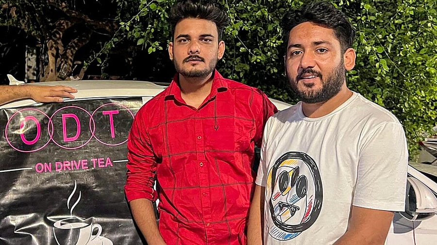 Mannu Sharma and Amit Kashyap, who sell tea for Rs 20 from the trunk of a luxury car, worth Rs 70 lakh, in Mumbai. Credit: PTI Photo