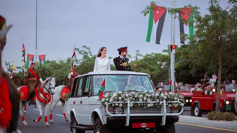Jordan's Crown Prince Hussein and Rajwa Al Saif travel in a motorcade on the day of their royal wedding, in Amman, Jordan, June 1, 2023. Credit: Reuters Photo