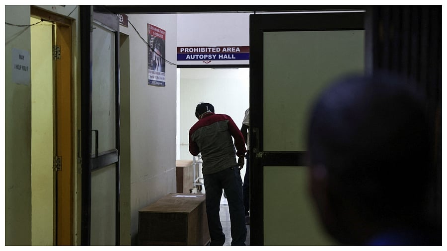 People view makeshift coffins to try and identify a family member killed after a train collision in Balasore, at a hospital in Bhubaneswar. Credit; Reuters Photo