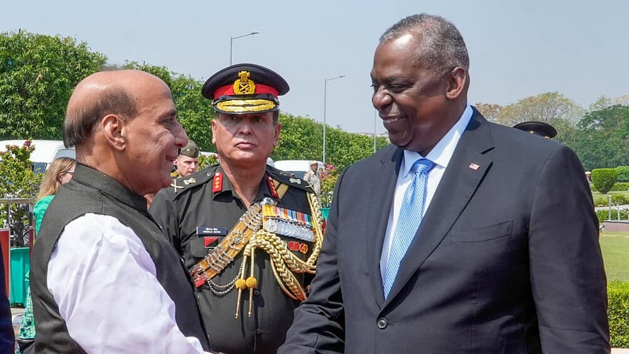 Defence Minister Rajnath Singh shake hands with US Secretary of Defence Lloyd Austin. Credit: PTI Photo