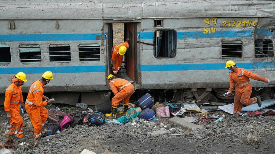 NDRF personnel during the restoration work at the site of Friday's triple train accident near Bahanaga Bazar railway station, in Balasore district, Sunday, June 4, 2023. At least 288 people were killed and over 1000 others suffered injuries in the accident, according to officials.  Credit: PTI Photo