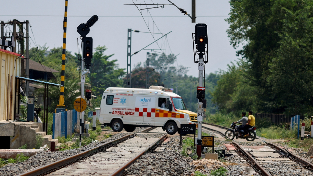 An ambulance carrying the dead bodies of victims of the train collision drive pasts a railway crossing, in Balasore district of Odisha, June 4, 2023. Credit: Reuters Photo