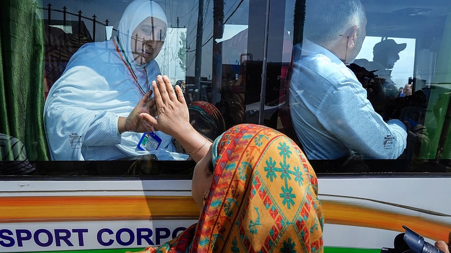 A Haj pilgrim waves to her relative as she leaves for the annual pilgrimage to Mecca. Credit: PTI Photo