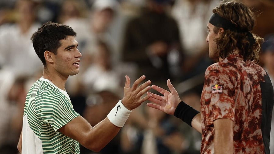 Spain's Carlos Alcaraz shakes hands with Greece's Stefanos Tsitsipas after winning his quarter final match
