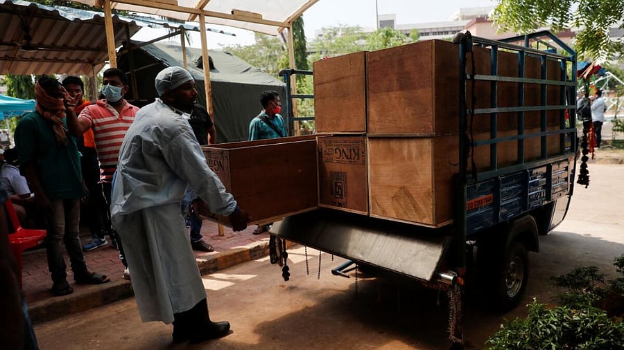 Man carries empty coffin after Odisha train crash. Credit: Reuters Photo