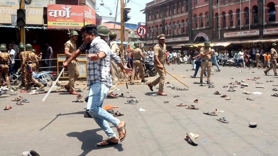Security personnel disperse people protesting against the alleged use of Tipu Sultan's image in objectionable social media posts. Credit: IANS Photo