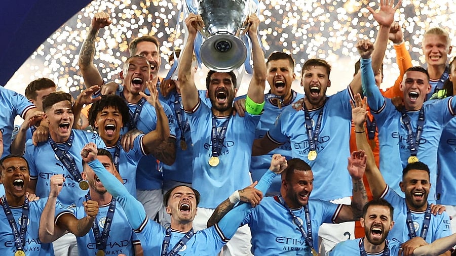 Manchester City's Ilkay Gundogan lifts the trophy as he celebrates with teammates after winning the Champions League. Credit: Reuters Photo