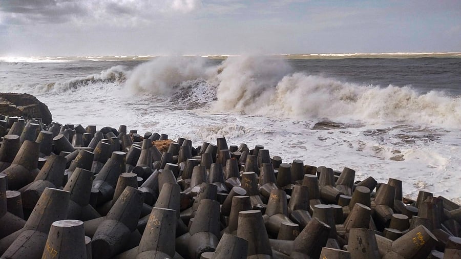 High waves crash against the jetty at a fishing harbour ahead of the expected landfall of Cyclone Biparjoy, in Porbander, Gujarat. Credit: PTI Photo