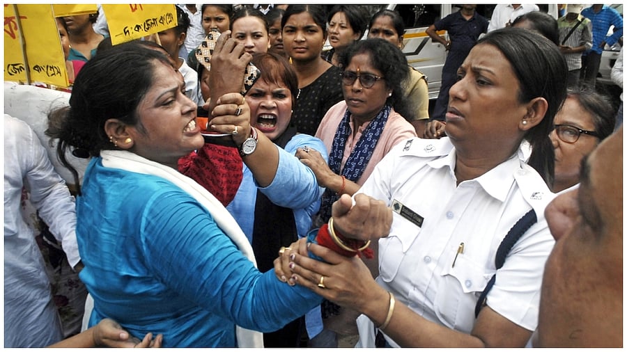 Police personnel detain Congress supporters during a protest in front of West Bengal State Election Commission office against the alleged killing of their party's worker in Murshidabad district ahead of Panchayat polls, in Kolkata, Saturday, June 10, 2023. Credit: IANS Photo