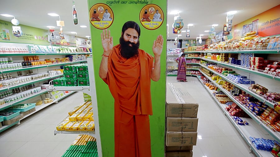 A hoarding with an image of Baba Ramdev is seen inside a Patanjali store in Ahmedabad. Credit: Reuters File Photo