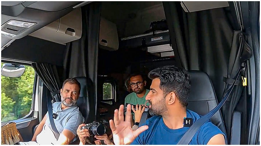  Congress leader Rahul Gandhi interacts with an Indian American truck driver while traveling in his truck from Washington DC to New York. Credit: PTI Photo