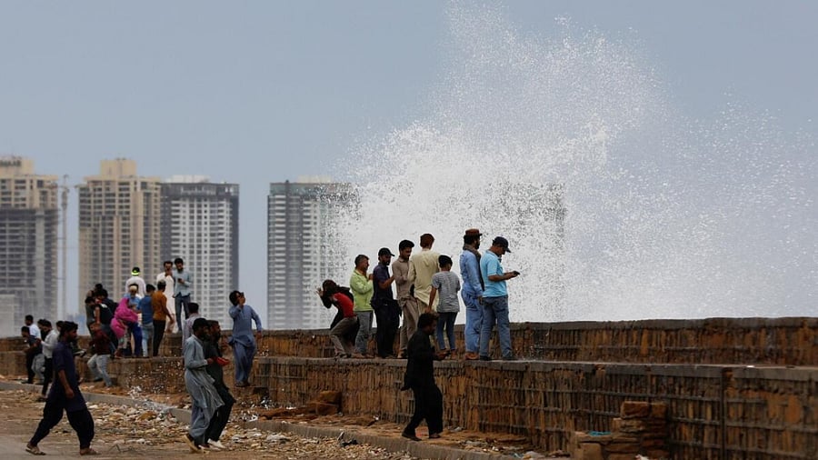 People gather near the rising waves, before the arrival of the cyclonic storm, Biparjoy, over the Arabian Sea, at Clifton Beach, in Karachi, Pakistan June 13, 2023. Credit: Reuters Photo
