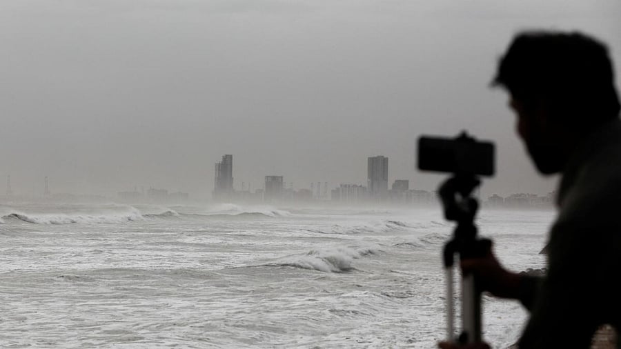 A man films the sea waves with his mobile phone, before the arrival of the cyclonic storm, Biparjoy, over the Arabian Sea, at Clifton Beach, in Karachi, Pakistan June 13, 2023. Credit: Reuters Photo